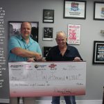 Donavon Bankhead of Springfield Music presents a check for $1800 to Play It Forward SWMO. This account will be used to purchase and repair instruments for children that cannot afford to take part in the music experience.